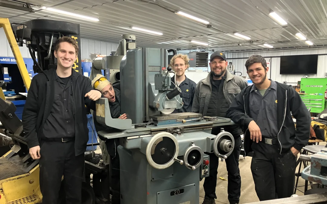 Micron's donation of a Gallmeyer & Livingstone hydraulic grinder pictured with students from Harmel Academy of the Trades